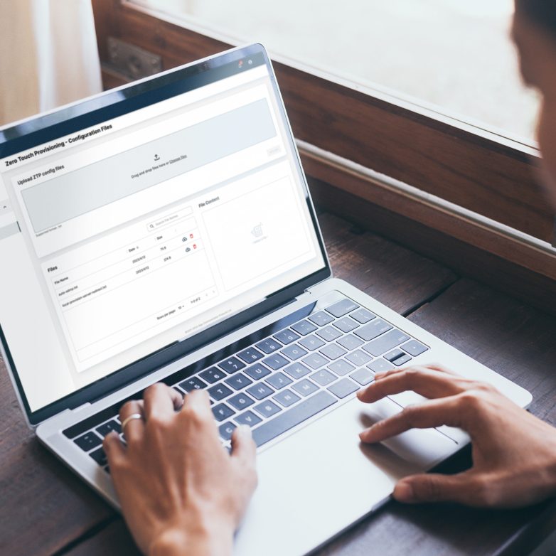 Person on a laptop using ZTP to configure their devices remotely.